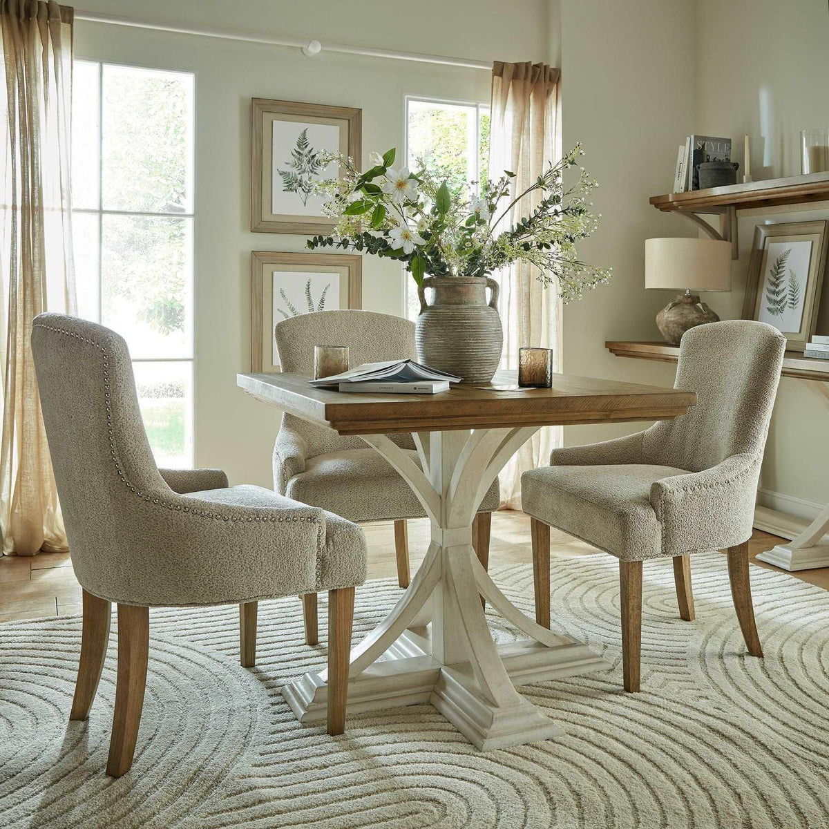 Handcrafted wooden dining table and four upholstered chairs in a bright, elegant room