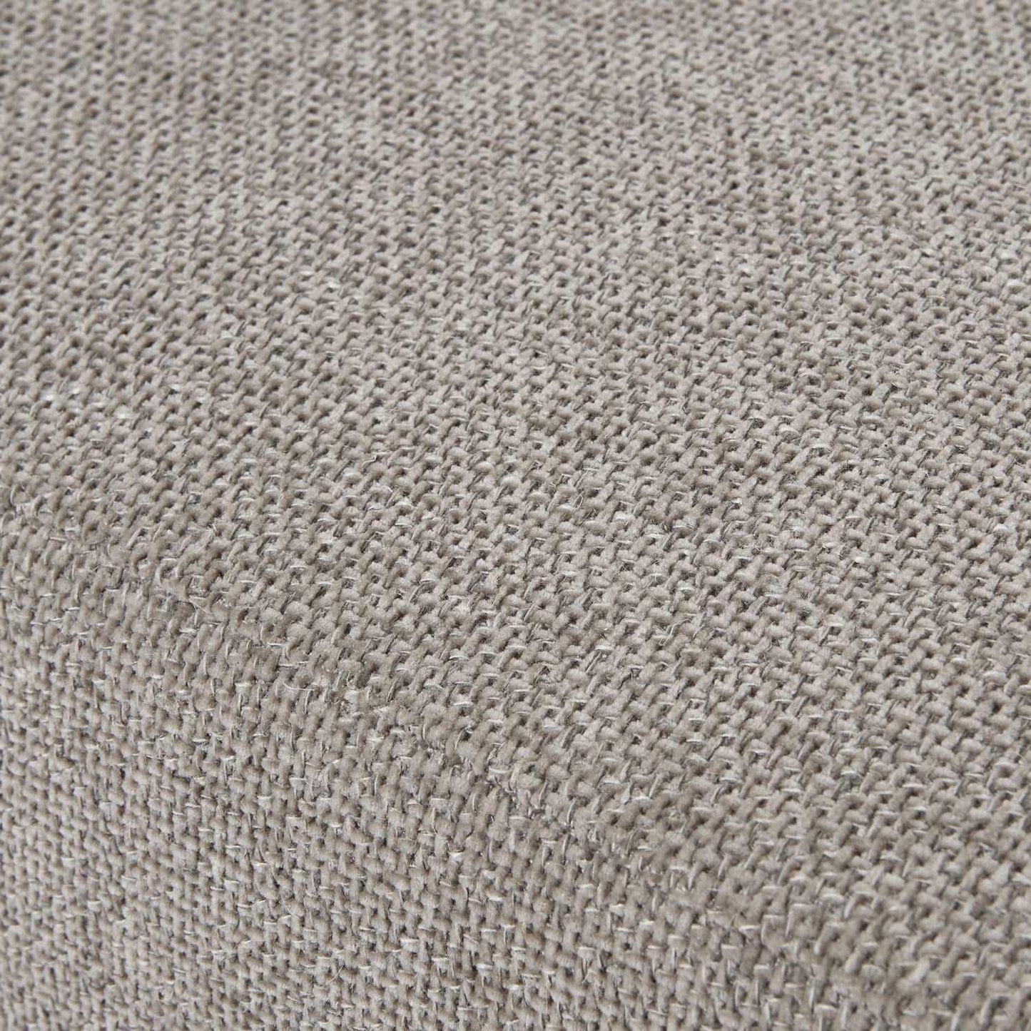 Close-up of textured beige woven fabric upholstery on furniture corner