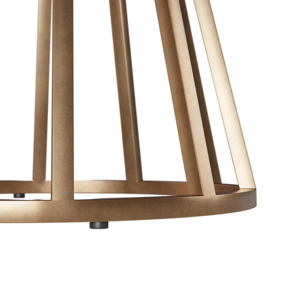 Close-up of a modern brass metal table base with geometric lines and matte finish