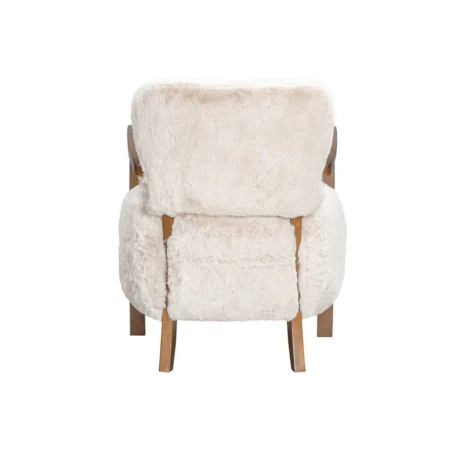 Rear view of a modern armchair with plush cream faux fur upholstery and wooden legs