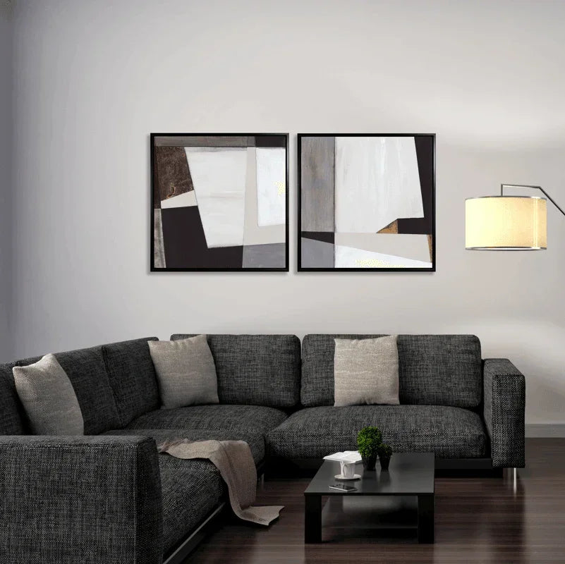 Modern living room with dark grey sectional sofa, abstract geometric wall art, and a stylish floor lamp.