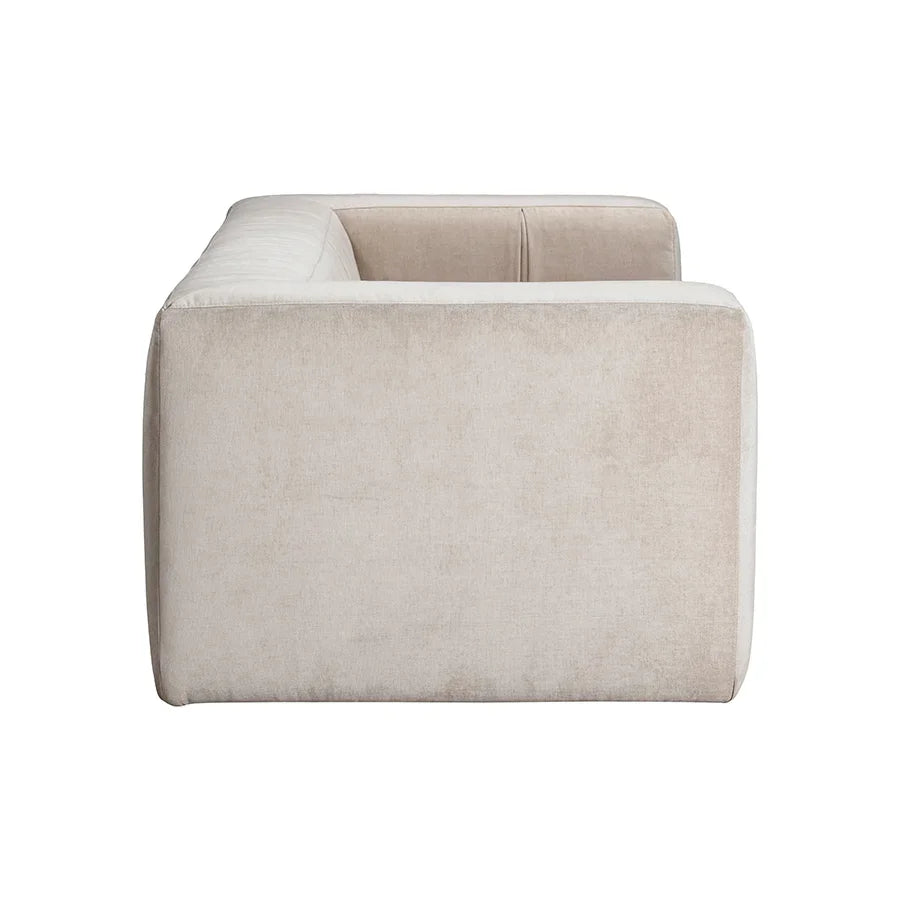 Side view of a modern beige upholstered sofa with clean, boxy lines on white background