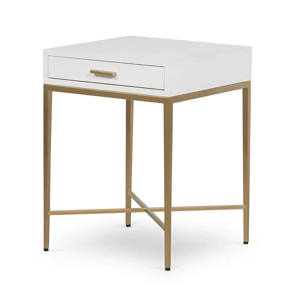 Modern white bedside table with gold metal legs and single drawer