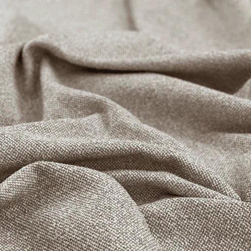Close-up of textured mink-colored sustainable furniture fabric with soft drape