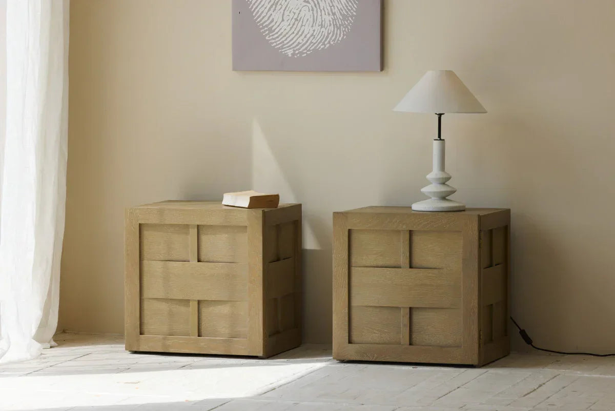 Pair of modern oak cube side tables in a minimal living room, one with a sculptural white lamp.