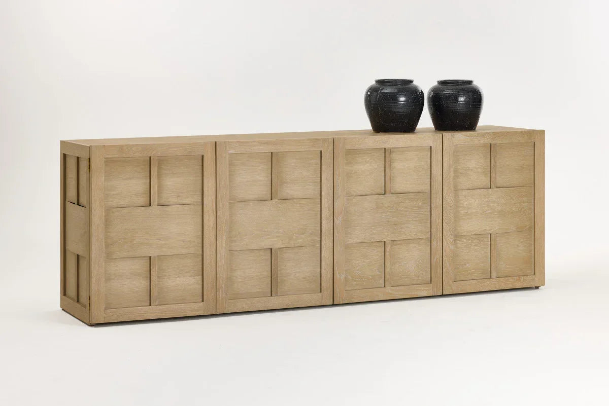 Modern light oak sideboard with geometric panel doors and two black vases on top.  Broadway sideboard
