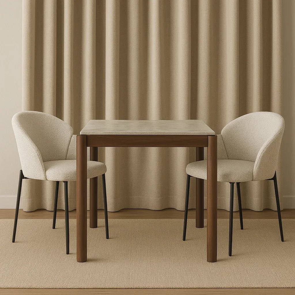 Modern square wood dining table with two cream upholstered chairs on neutral rug